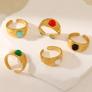 Retro 18K gold-plated rings set featuring colorful gemstones on decorative stone slabs
