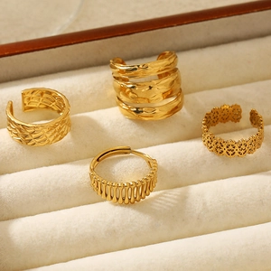 Set of four French-style gold stainless steel rings with minimalist textured designs