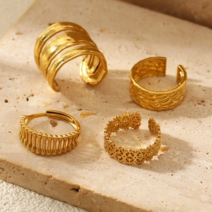Set of four gold stainless steel open rings with unique textured hollow patterns