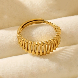 Detailed macro view of adjustable golden grain-textured hollow ring in velvet jewelry box