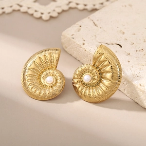 Golden nautilus shell earrings with pearl inlay on minimalist stone background