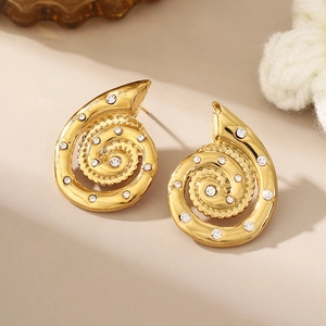 Detail view of gold-plated spiral conch earrings with sparkling inlaid zircons