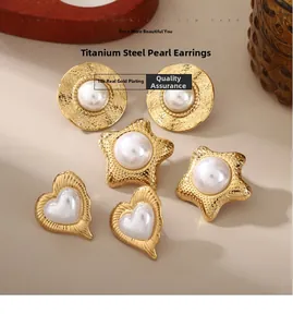 Detailed macro of 18k gold plated titanium earrings with round, star and heart pearls