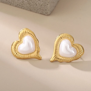 Elegant gold heart earrings with white pearl inlay and textured ripple edges for women