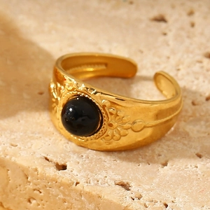 Retro golden adjustable ring with floral relief and a round black natural stone center