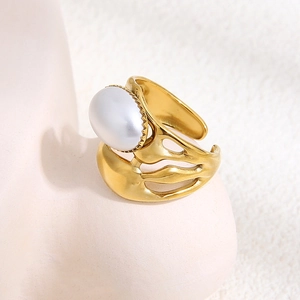 Irregular gold titanium steel open ring featuring a large oval pearl and hollow texture