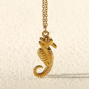 Elegant gold seahorse pendant necklace in stainless steel with a textured relief design