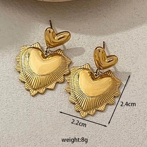 Detail showing gold heart earrings with sunburst texture, size 2.4cm by 2.2cm, weight 8g