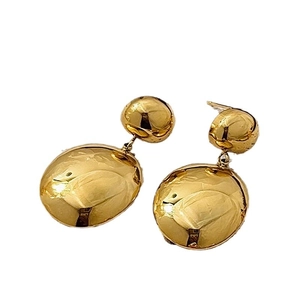 Minimalist gold-tone drop earrings featuring high-polish spherical and oval metal pendants