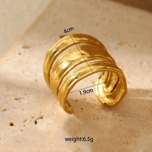 Macro detail of wide gold hammered stainless steel ring with dimensions and weight