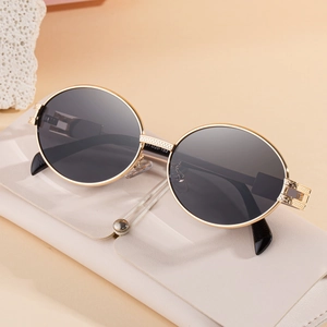 Retro oval sunglasses with gold metal frame and dark lenses, including leather case