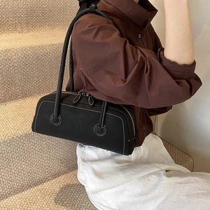 Classic black leather tote bag with white contrast stitching and double zipper closure