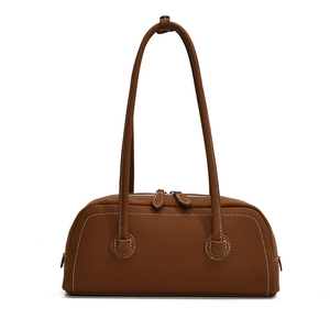 Brown vintage tote bag with long handles and white contrast stitching on white background