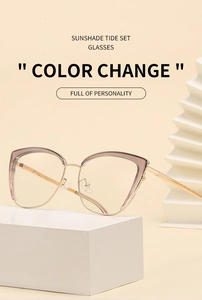 Detail of cat-eye color-changing sunglasses on geometric display with pink frame