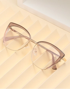 Detail of cat-eye frames featuring translucent tea-purple upper and gold metal semi-rim