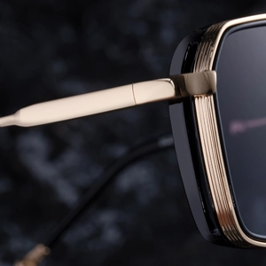 Macro detail of high-quality gold metal hinges and black frame on punk style sunglasses