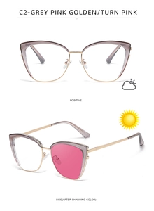 Detail view of cat eye photochromic sunglasses changing from grey to pink with golden frame