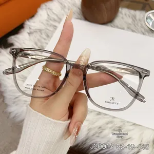 Detail view of transparent grey acetate glasses frame with durable metal hinges