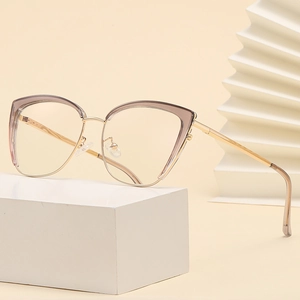 Chic cat eye sunglasses with gold metal frame and translucent accents on a white stand