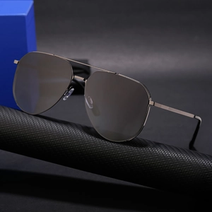 Polarized pilot sunglasses for men with dark gray metal frame on a carbon fiber stand
