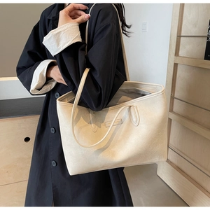Top view of beige tote bag showing spacious grey fabric interior and secure zipper closure