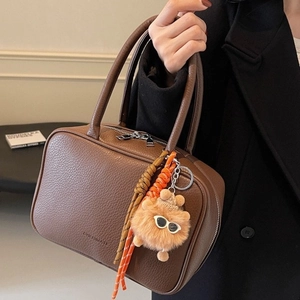 Retro dark brown pebbled leather bowling bag with vintage charms and dual top handles