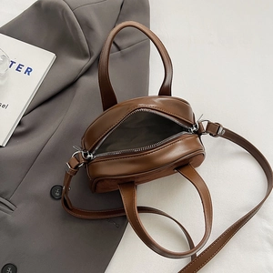 Detail view of brown vintage mini bag with leather texture and fabric lining