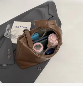 Internal view showing large capacity storage and compartments of brown vintage tote bag