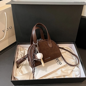 Retro brown frosted leather handbag with baseball charm and zip closure in a gift box