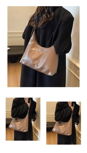 Detail of a large brown faux leather tote with white CHERIMATE lettering and strap detail