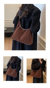 Detailed close-up of brown suede shoulder bag with high-quality leather trim and large capacity
