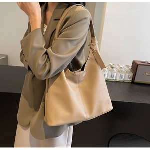 Close-up of beige lychee grain leather tote bag with shoulder strap for work