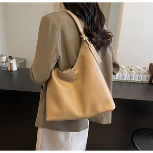 Detail view of khaki leather tote bag featuring a high-quality pebble texture and large capacity
