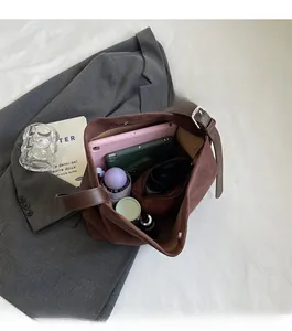 Open view showing large storage capacity of dark brown suede shoulder bag for daily items