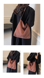 Close-up of a large tan suede tote bag with soft texture and slim shoulder straps