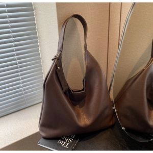 Close-up of brown litchi pattern leather tote bag showing rich texture and hobo style