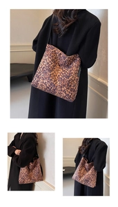 Detailed close-up of the leopard print suede tote bag with black shoulder straps for women