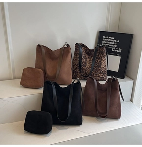 Detail of four suede hobo bags in assorted colors with matching interior pouches
