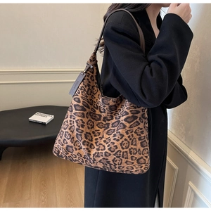 Detail of large leopard print hobo bag with dark brown leather strap for fashion