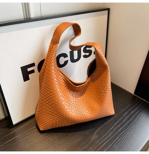 Detail of the woven texture and soft PU leather on this large brown hobo shoulder bag