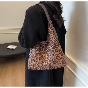 Detailed view of high-capacity leopard print hobo shoulder bag with leather straps