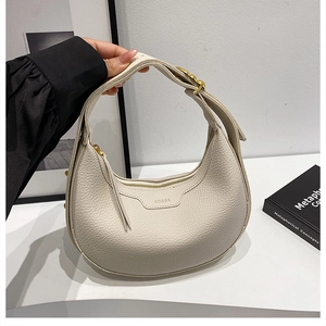 Detail of off-white hobo bag showing high-quality lychee grain leather and logo