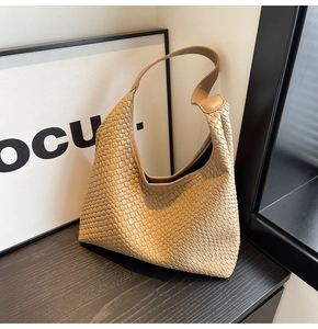 Detailed close-up of beige woven texture and hobo design on a large tote shoulder bag