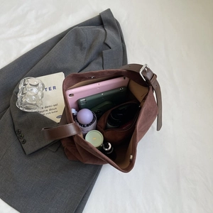 Spacious dark brown suede tote bag interior showing large capacity for tablets and cosmetics