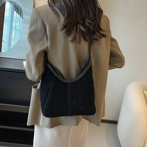 Women's black matte crescent shoulder bag with vertical stitching for commuter style