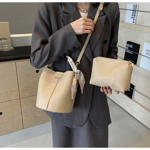 Detail of beige lychee pattern bucket bag set with silk scarf and adjustable strap