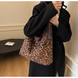 Leopard print tote bag shown on a model's shoulder for large-capacity commuter style
