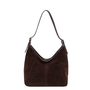 Dark brown matte suede hobo bag with adjustable leather strap in a minimalist retro style