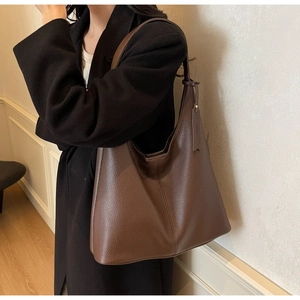 Detailed close-up of dark brown lychee texture leather shoulder bag for women