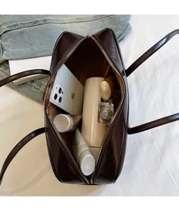 Top view of deep brown glossy leather bag showing its large interior storage capacity